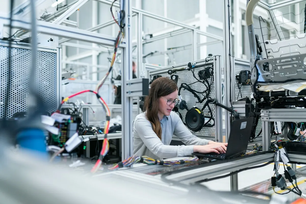 Engineer with a laptop on the factory floor