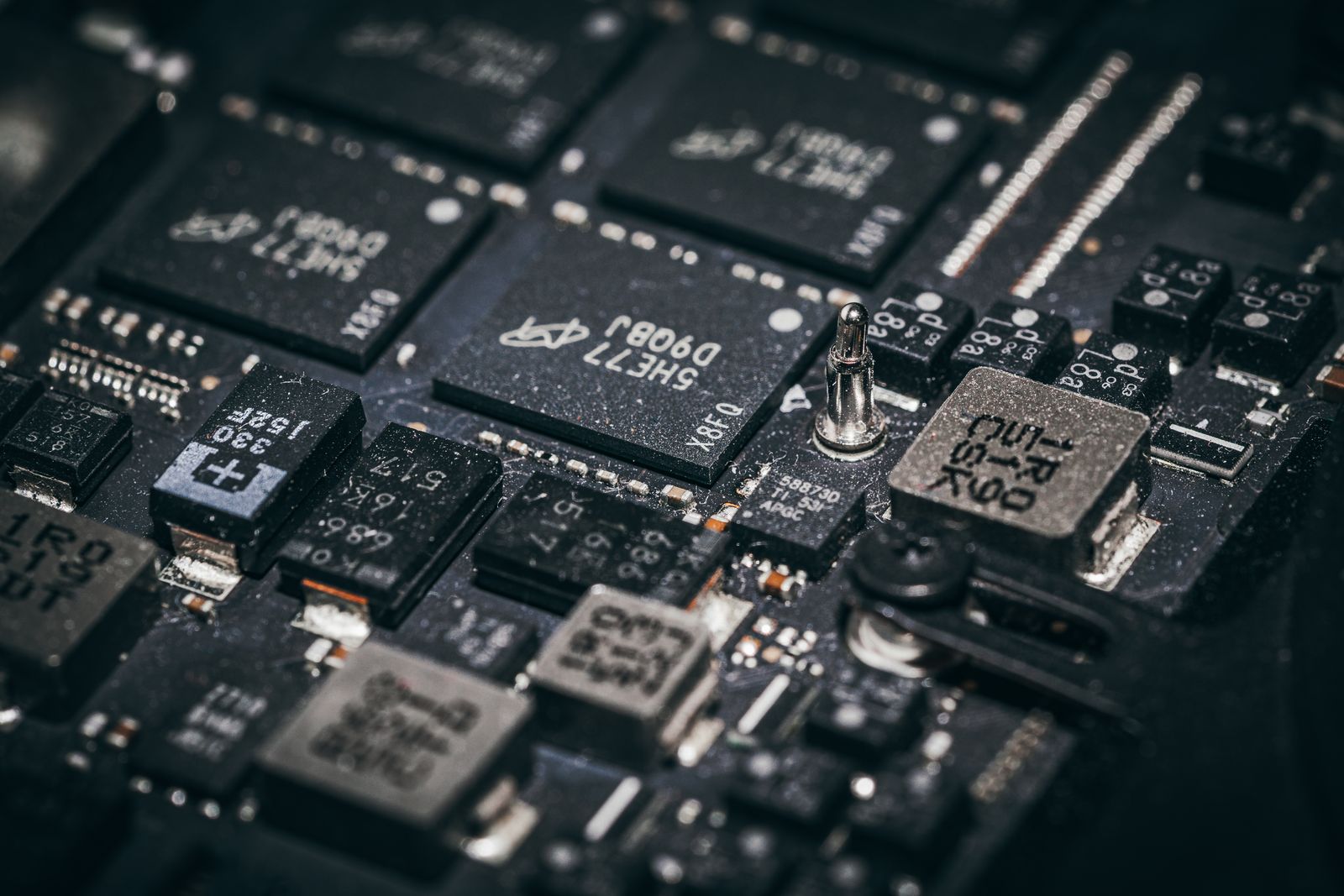 Macro close-up of memory chips and components on a dark circuit board